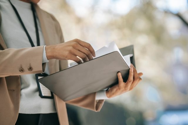 person looking in a binder 
