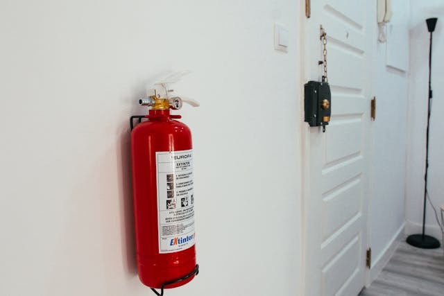 fire extinguisher on a white wall