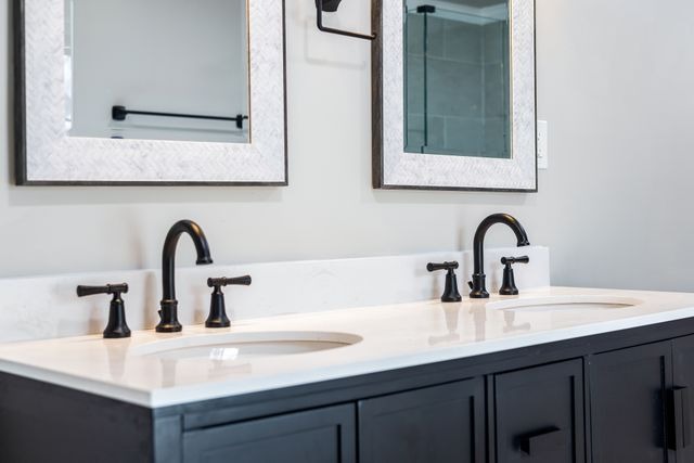double sinks with black cabinets