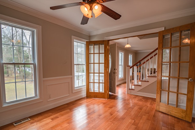 a vacant home with wooden floors and French doors leading to a living room