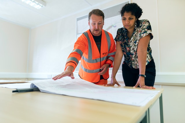 contractor and property owners looking over a home maintenance plan