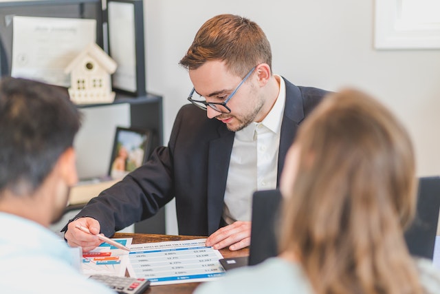 financial expert looking over mortgage options with potential home buyers