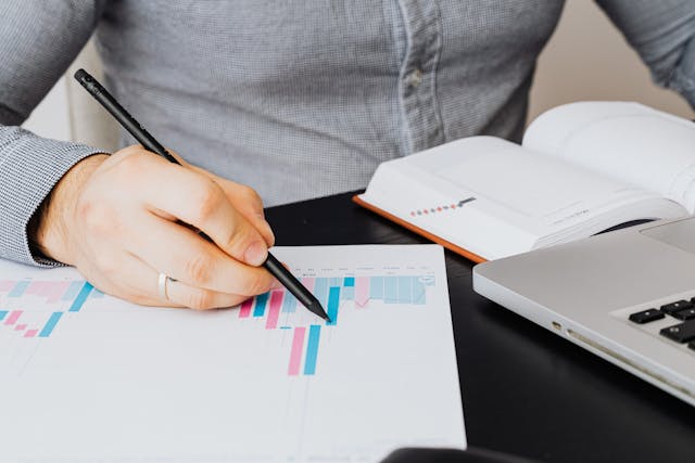 person looking at graphs on paper.jpg