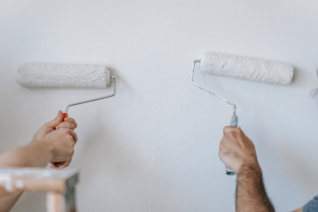 two paint rollers with white paint